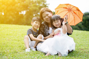 Happy Asian Family Enjoying Day In Park