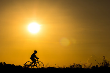 Fototapeta premium Silhouette of cyclist in motion
