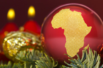 Fototapeta na wymiar Red bauble with the golden shape of Africa.(series)