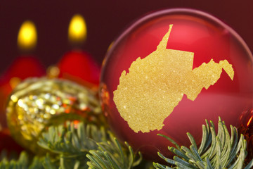 Fototapeta na wymiar Red bauble with the golden shape of West Virginia.(series)