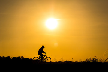 Fototapeta premium Silhouette of cyclist in motion