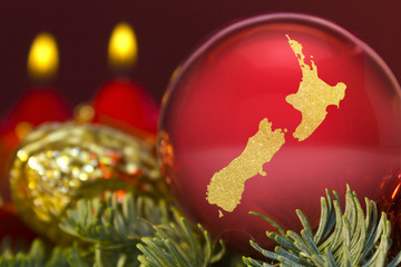 Red bauble with the golden shape of New Zealand.(series)