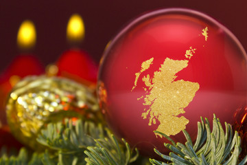 Red bauble with the golden shape of Scotland.(series)