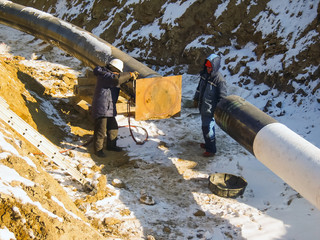 The workers engaged in the construction of the pipeline. Welders build the pipeline. Installation work in the construction and installation of the pipeline