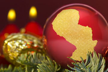 Red bauble with the golden shape of Paraguay.(series)