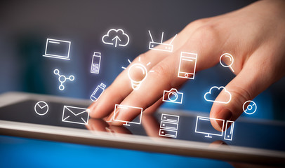 Fingers touching tablet with icons