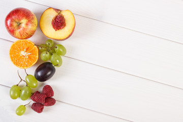 Fresh ripe fruits on white boards, healthy nutrition, copy space for text
