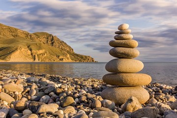 pebble stack on the sea coast line and mountains