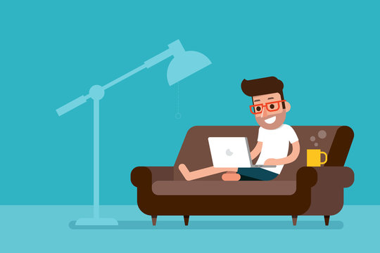 Freelancer working at home with laptop computer on cozy sofa.