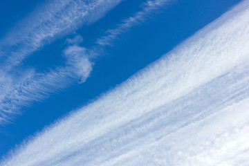 Fototapeta na wymiar blue sky with white clouds on the diagonal