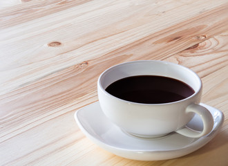 coffee cup on  pine wooden table.