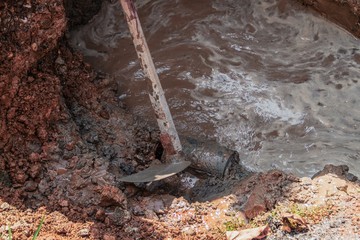 selective focus hoe, in dig hole repair plumbing, with water mot