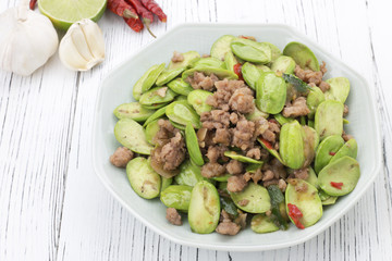 Sato fried pork spicy taste on wood table, thai food
