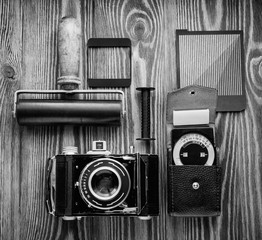 vintage camera,exposure meter and another trappings of film photography. photographer's desk.