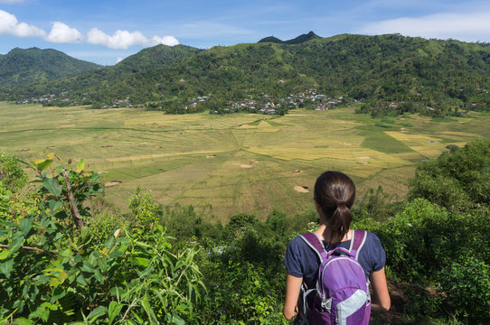 A backpacker and the lingko spider web rice fields, Cancar, Ruteng, Nusa Tenggara, Indonesia