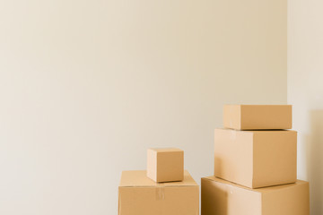 Variety of Packed Moving Boxes In Empty Room with Room For Text.