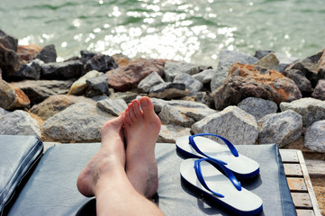 Taking off the slipper and relaxing by the sea