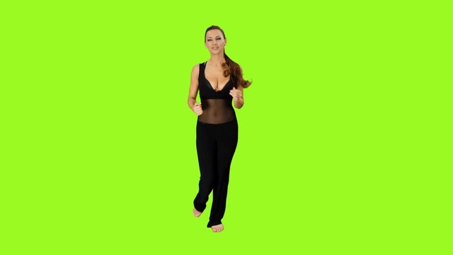 Young athletic woman is jogging on a green screen background. Full HD shot with alpha channel