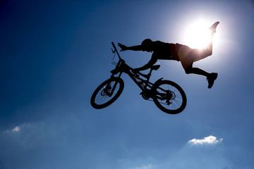 Silhouette biker blue sky