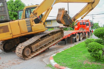 Excavator, bulldozer moving to construction site  © pramot48