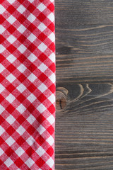 Obraz premium Red checkered napkin on gray wooden table