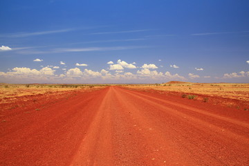Fototapeta na wymiar Dirt road across the Pilbara in Australian outback