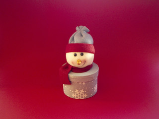 Snowman decoration on red background