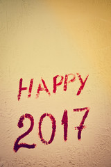 Sigh of Happy 2017 year written on light wall background, closeup