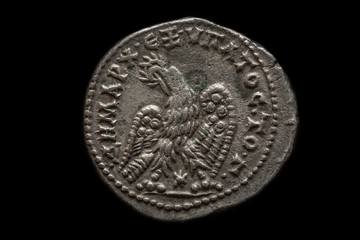 Antique silver roman coin with eagle image on it