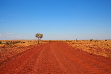 Fototapeta premium Dirt road across the Pilbara in Australian outback