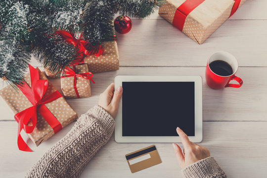 Woman christmas shopping online with a credit card