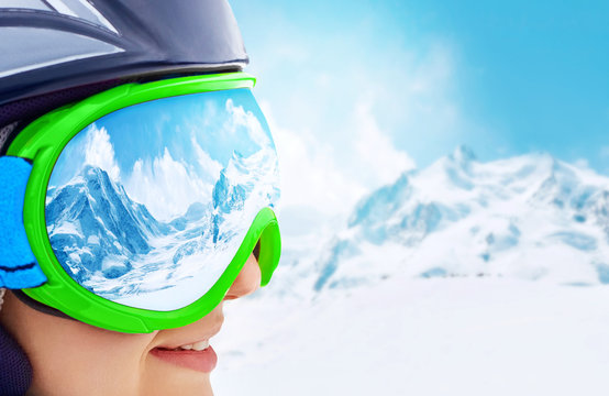 A mountain range reflected in the ski mask.Shallow depth of field.