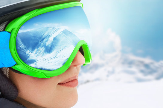 WinterSport, Snowboarding - portrait of young snowboarder girl at the ski resort.A Mountain Range Reflected in the Ski Mask
