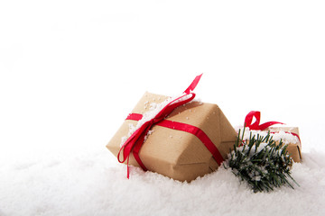 Christmas presents in brown paper with red ribbon