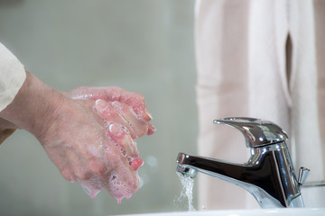 Thorough washing of hands under a tap
