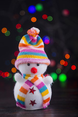 Toy cute snowman with colorful garland lights