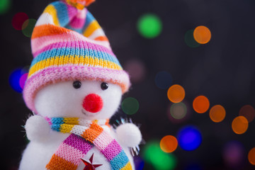 Toy cute snowman with colorful garland lights