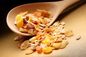 Heap of musli with raisin in wooden spoon
