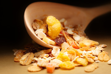 Heap of musli with raisin in wooden spoon