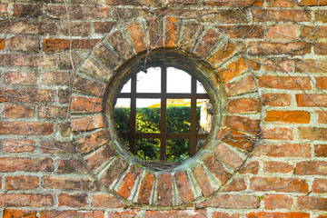 Old round window on brick wall