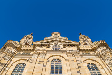 Famous Frauenkirche in the city center of Dresden, Germany in the morning sun with blue sky above.