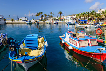 The scenic harbour with traditional fishing boats in the village of Kardamena, Kos island,...
