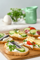 Variety of sandwiches on a cutting Board. Selective focus.