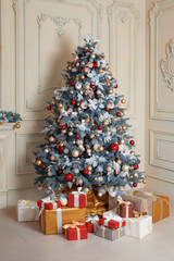 Beautiful holdiay decorated room with Christmas tree and presents under it. New Year decorations