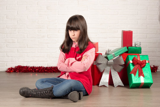 Angry Girl At Christmas With Gift Boxes