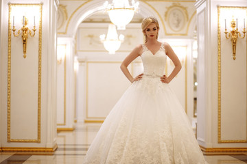 Fototapeta premium beautiful young woman bride in luxury wedding dress in interior