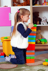Three-year girl playing and learning in preschool