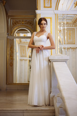 beautiful young woman bride in luxury wedding dress in interior