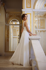 beautiful young woman bride in luxury wedding dress in interior