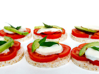 Healthy food - sandwiches, rice crackers with tomato, avocado and mozzarella cheese